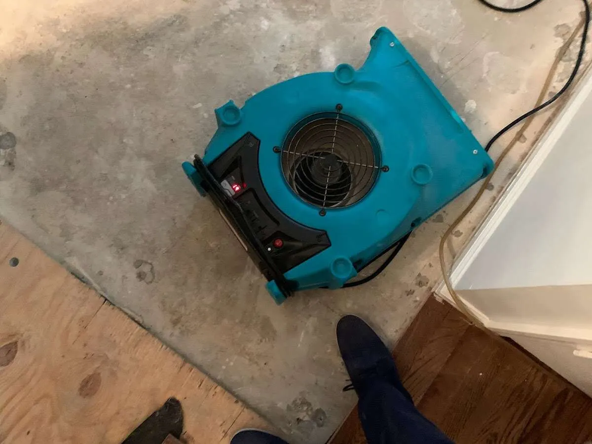 Air mover drying subfloor during Commercial Water Damage Restoration in Granite Shoals